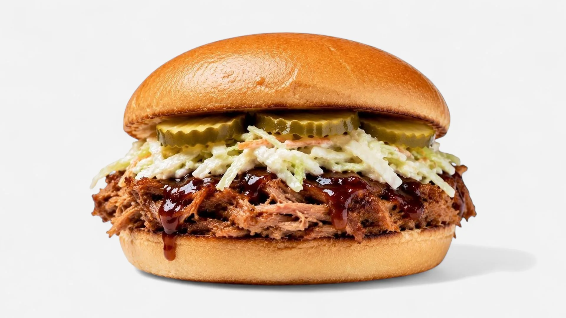 Pulled pork burger with BBQ sauce, coleslaw, and pickles at Texas Backyard.